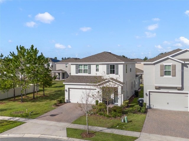 view of front of property featuring a garage and a front lawn