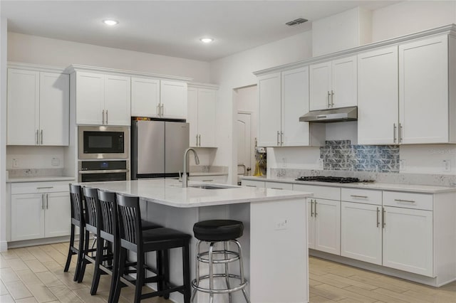 kitchen featuring white cabinetry, sink, and appliances with stainless steel finishes