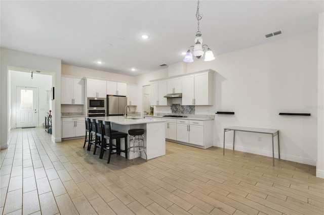 kitchen with white cabinetry, light hardwood / wood-style flooring, sink, and appliances with stainless steel finishes