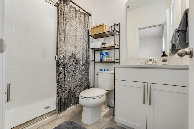 bathroom with toilet, vanity, tile patterned floors, and walk in shower