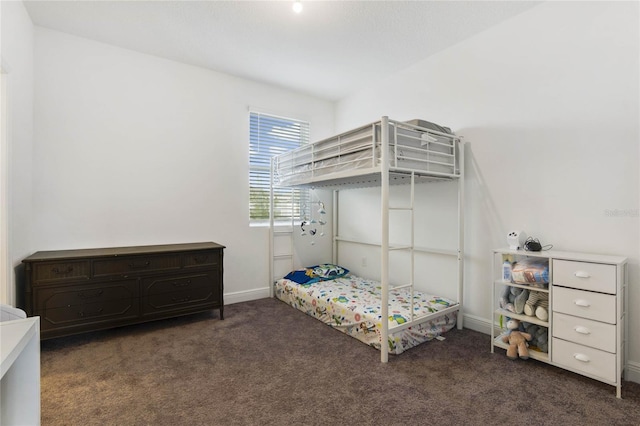 bedroom featuring dark carpet