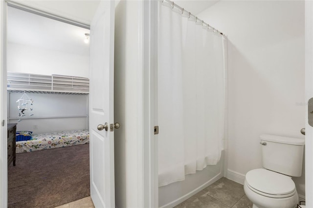 bathroom with tile patterned flooring, shower / bath combination with curtain, and toilet