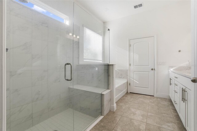 bathroom featuring tile patterned floors, plus walk in shower, and vanity