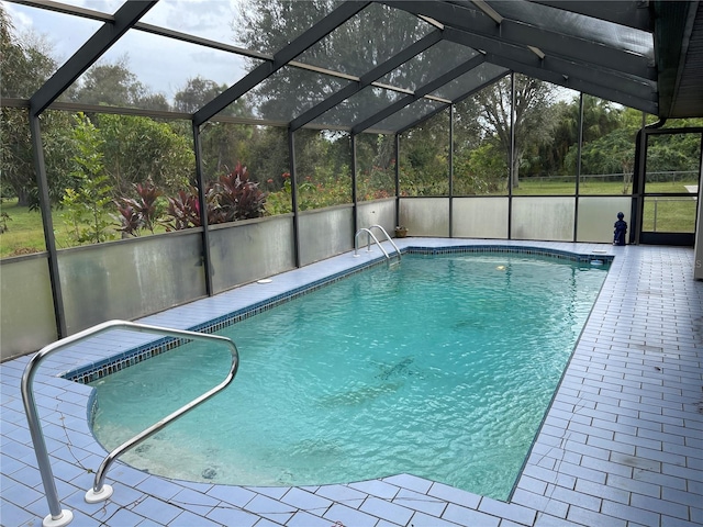 view of pool featuring a patio and glass enclosure