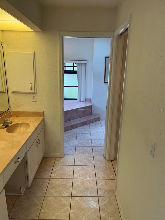 bathroom with vanity, a bathing tub, and tile patterned flooring