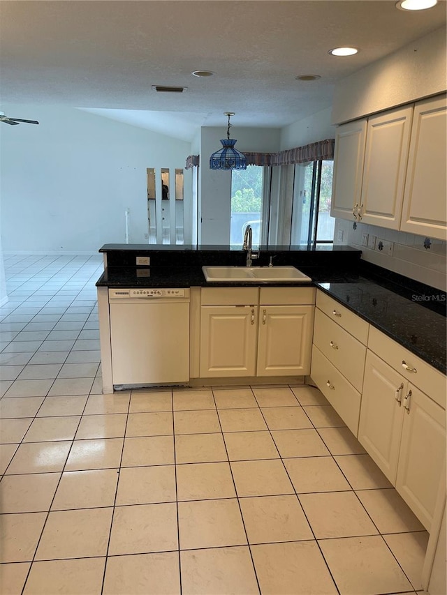 kitchen featuring white cabinetry, sink, white dishwasher, and light tile patterned floors