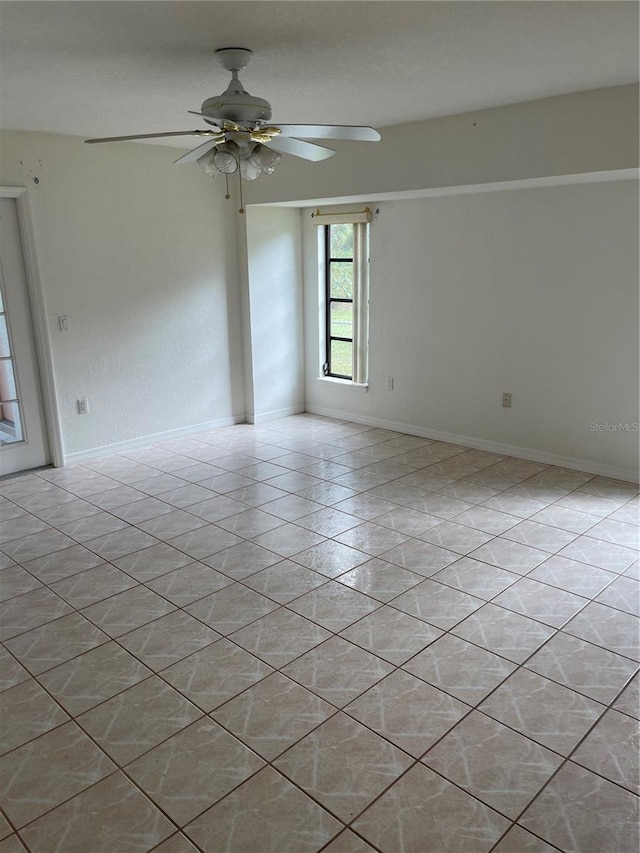 unfurnished room featuring light tile patterned floors and ceiling fan