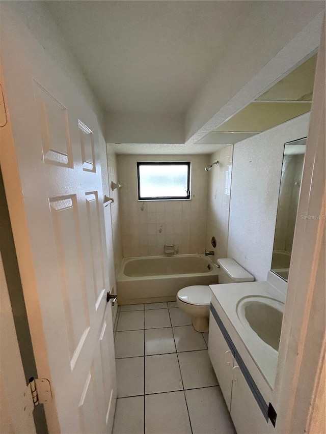 full bathroom with vanity, tiled shower / bath, toilet, and tile patterned floors