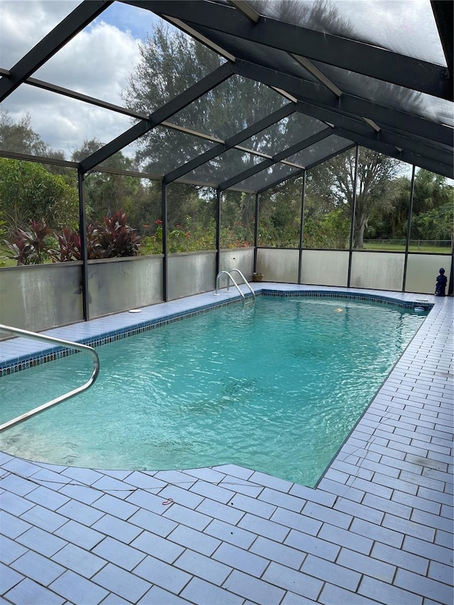 view of pool featuring a patio area and a lanai