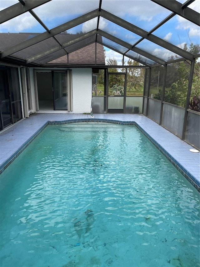 view of swimming pool with a lanai