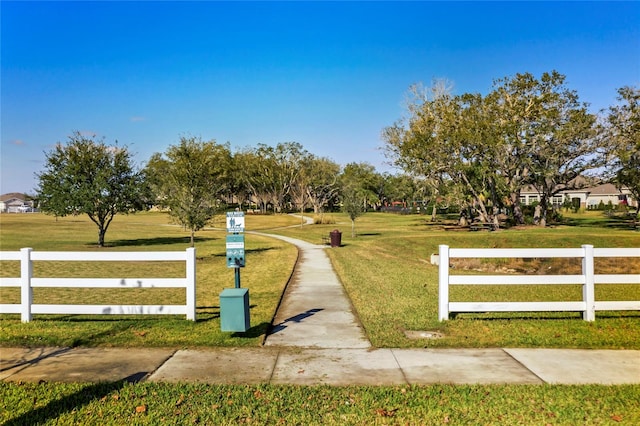 view of property's community with a lawn