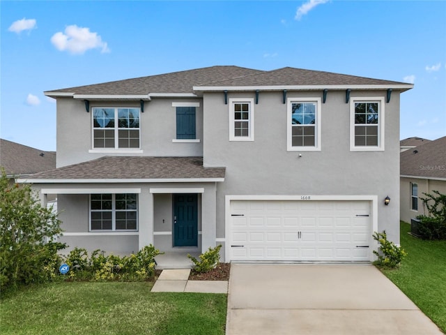 view of front of home featuring a front lawn and a garage