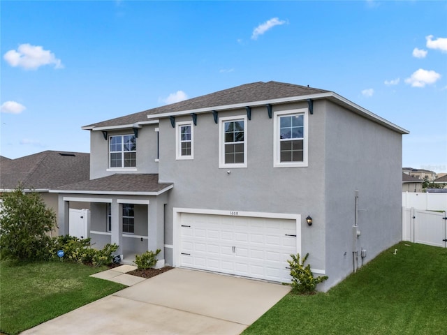 view of property featuring a front lawn and a garage