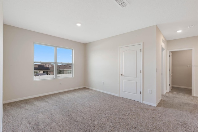 spare room with light colored carpet