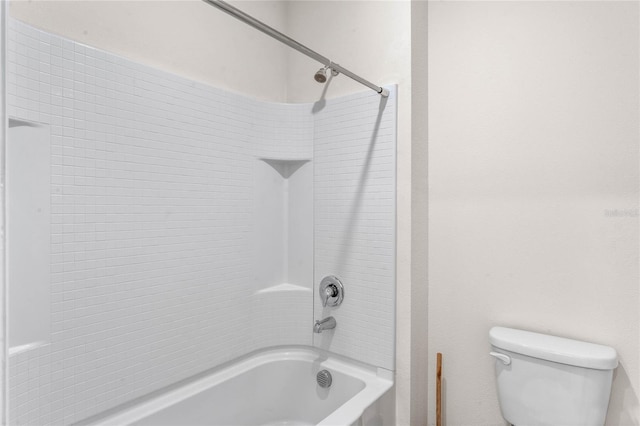 bathroom with tub / shower combination and toilet