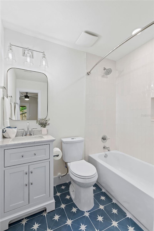 full bathroom with toilet, ceiling fan, vanity, tiled shower / bath combo, and tile patterned flooring