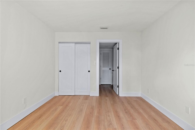 unfurnished bedroom featuring a closet and light hardwood / wood-style floors