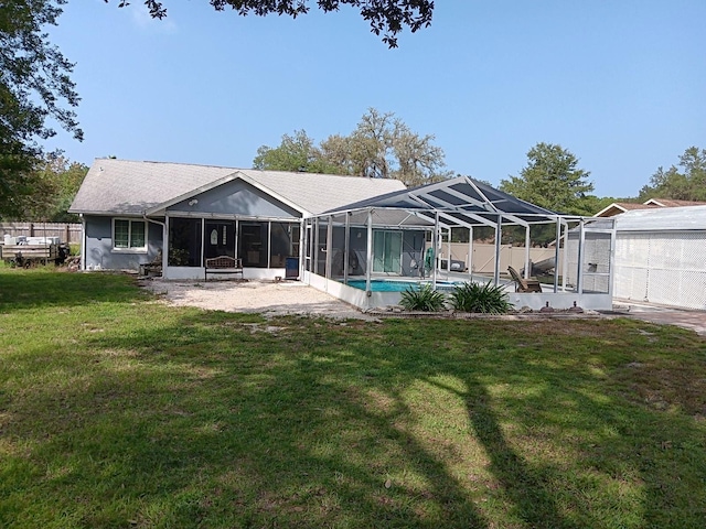 rear view of house featuring a patio, a lanai, a sunroom, and a yard