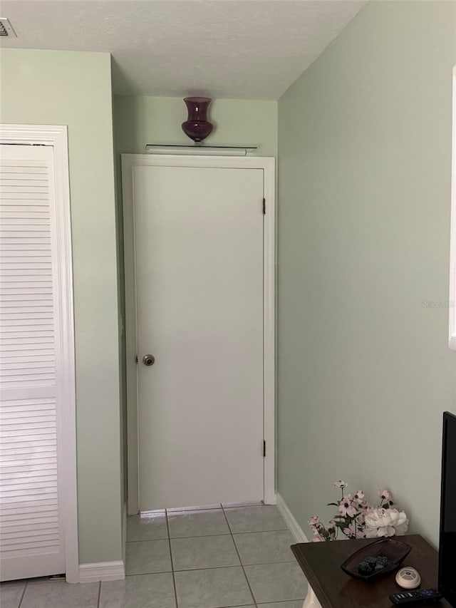 hallway featuring light tile patterned flooring