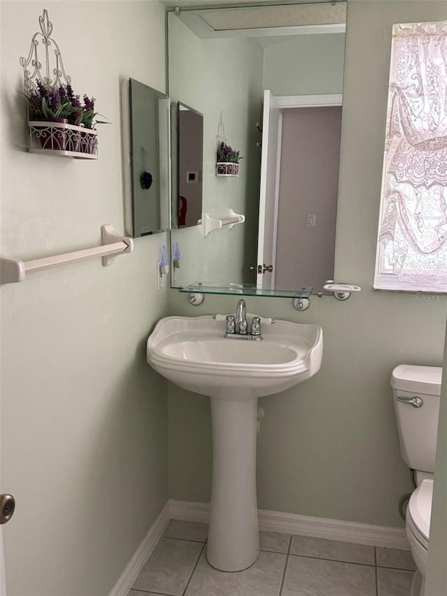 bathroom featuring tile patterned flooring and toilet