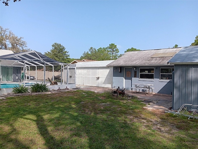 view of yard featuring glass enclosure and a patio