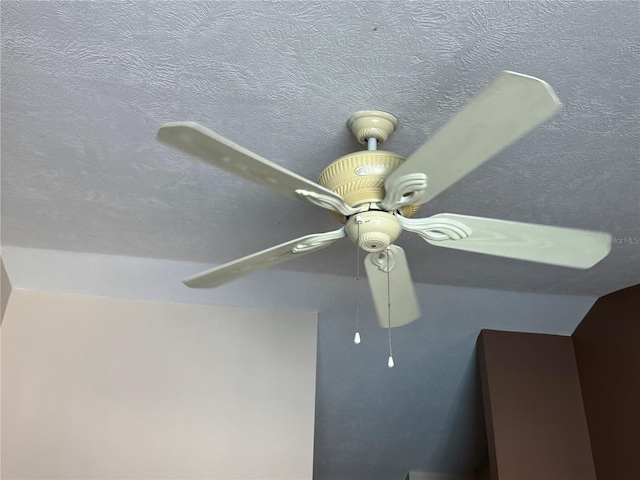 details featuring a textured ceiling and ceiling fan