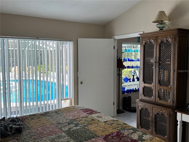 tiled bedroom featuring access to outside and lofted ceiling