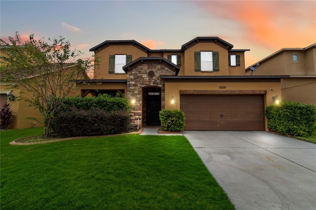 view of front of home with a lawn and a garage