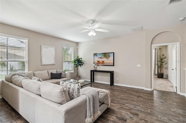 living room with dark hardwood / wood-style floors and ceiling fan