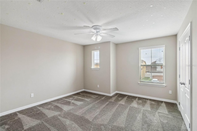 spare room with ceiling fan, carpet, and a textured ceiling