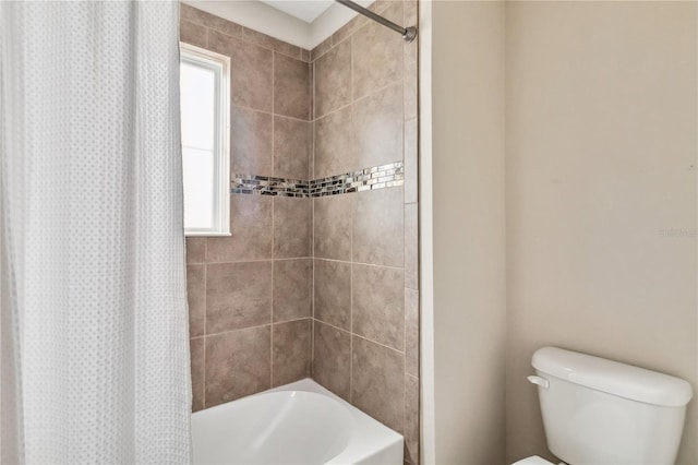 bathroom with shower / bath combo, toilet, and plenty of natural light