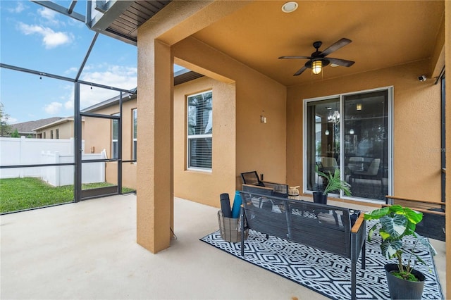 view of patio featuring a lanai and ceiling fan