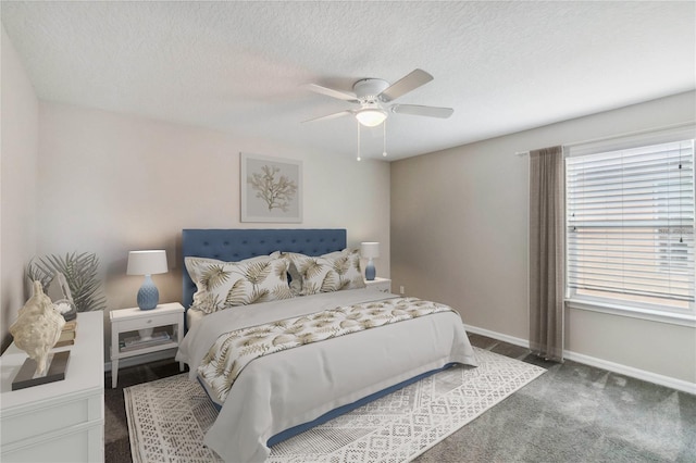 bedroom with dark carpet, a textured ceiling, and ceiling fan