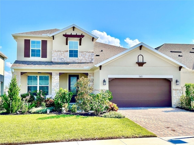 view of front of home with a front yard and a garage