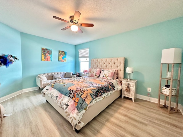 bedroom with ceiling fan, a textured ceiling, and light hardwood / wood-style floors