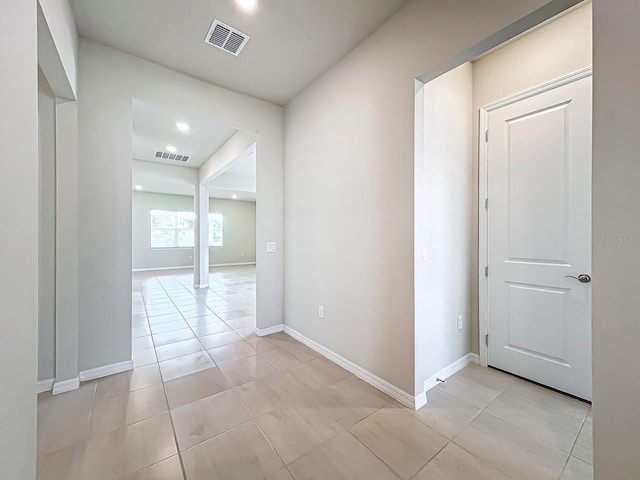 corridor featuring light tile patterned floors