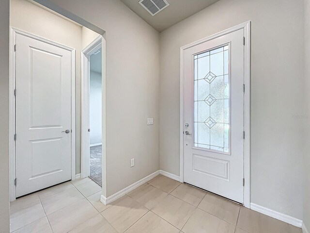 foyer featuring light tile patterned floors