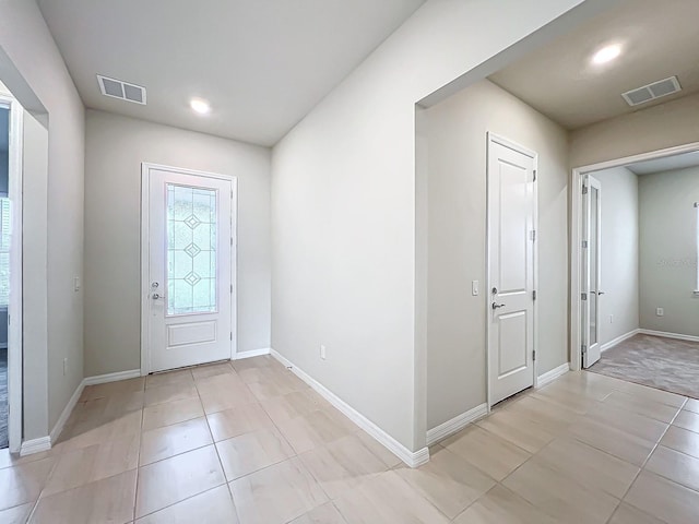 entryway with light tile patterned floors