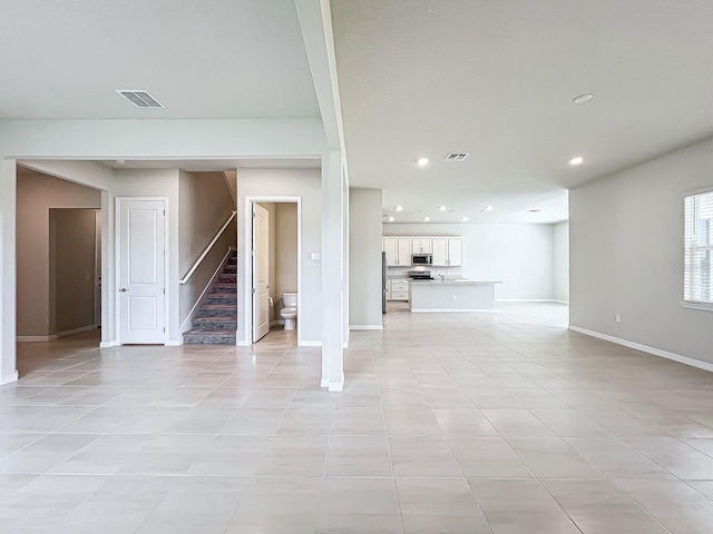 unfurnished living room with light tile patterned floors