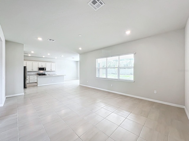 unfurnished living room with light tile patterned floors