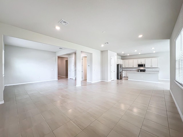 unfurnished living room featuring light tile patterned floors