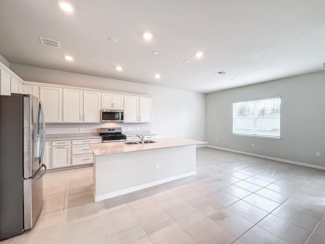 kitchen featuring white cabinetry, a kitchen island with sink, stainless steel appliances, and sink