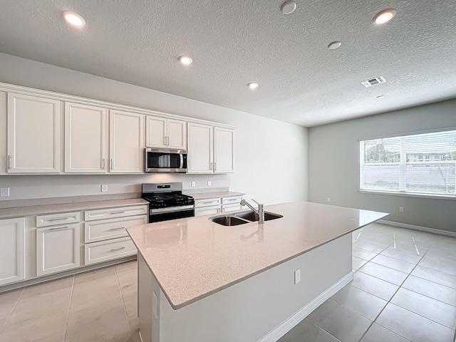 kitchen featuring white cabinetry, a center island with sink, stainless steel appliances, and sink