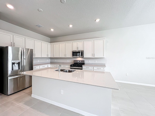 kitchen featuring appliances with stainless steel finishes, white cabinetry, a kitchen island with sink, and sink