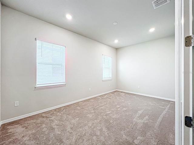 carpeted spare room with plenty of natural light