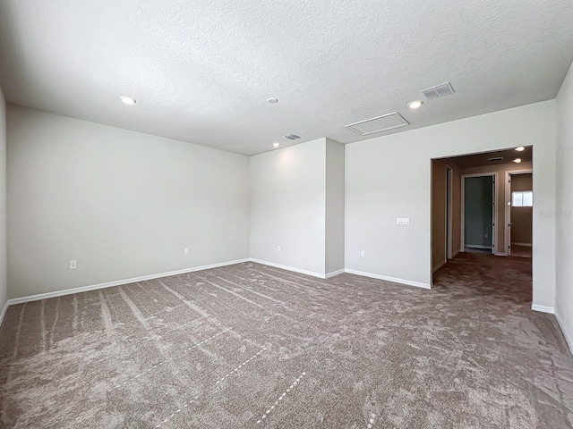 carpeted spare room featuring a textured ceiling