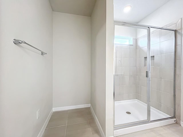 bathroom with tile patterned flooring and an enclosed shower