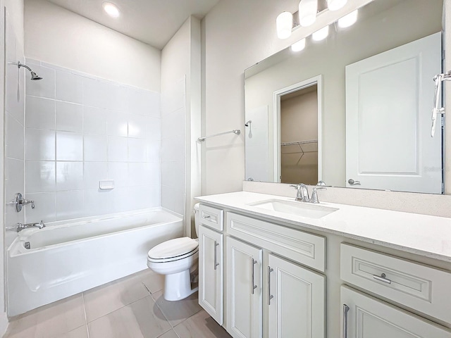 full bathroom with vanity, tiled shower / bath combo, toilet, and tile patterned flooring