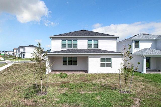 rear view of property with a patio area and a lawn