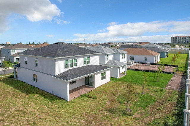 rear view of house featuring a patio and a yard